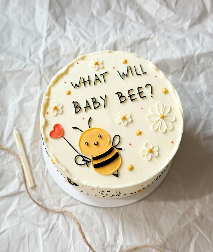 Bee Gender Reveal Bento - yellow, white, red theme with hand-drawn bee character holding a heart and piped white daisies w...