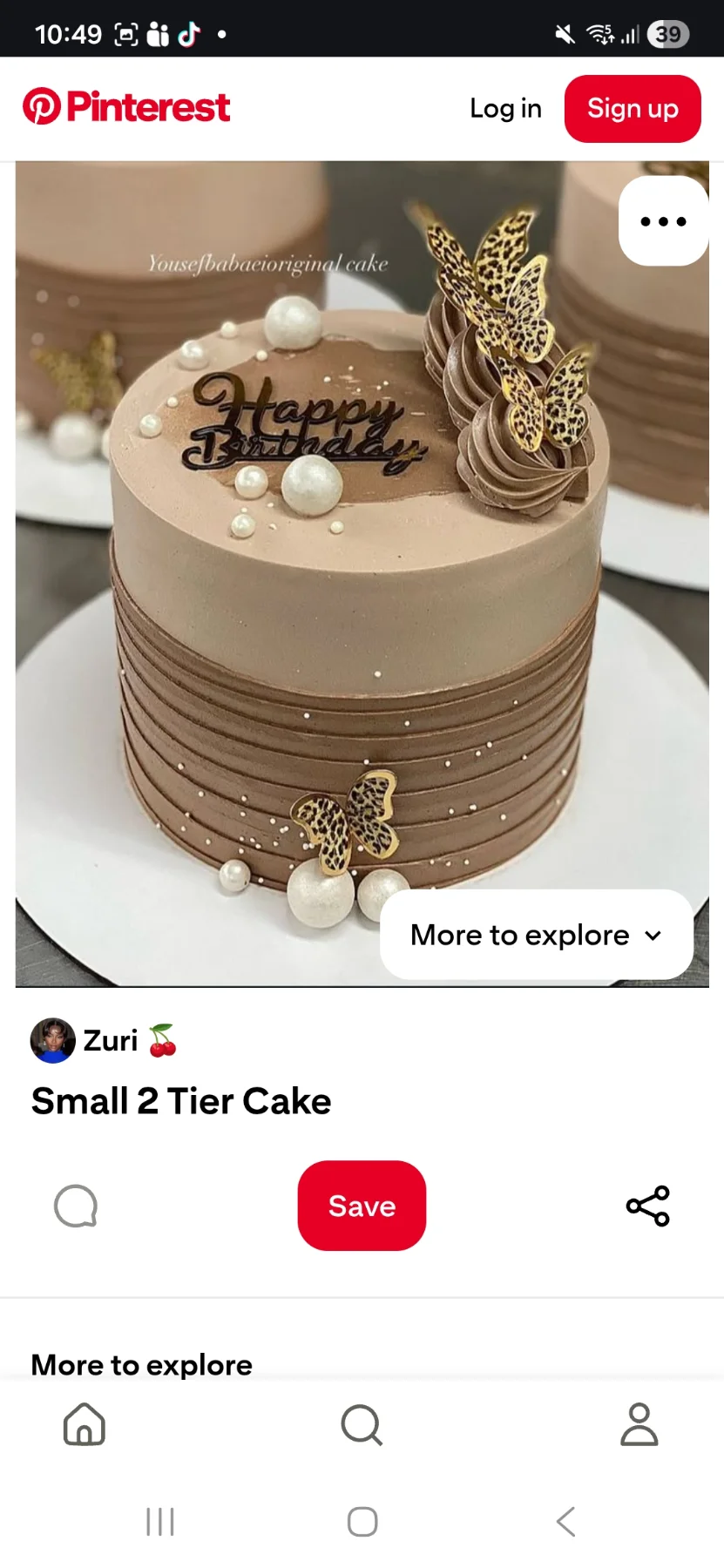 Brown 1-tier birthday cake with leopard print butterflies, white pearls, and chocolate icing swirls.