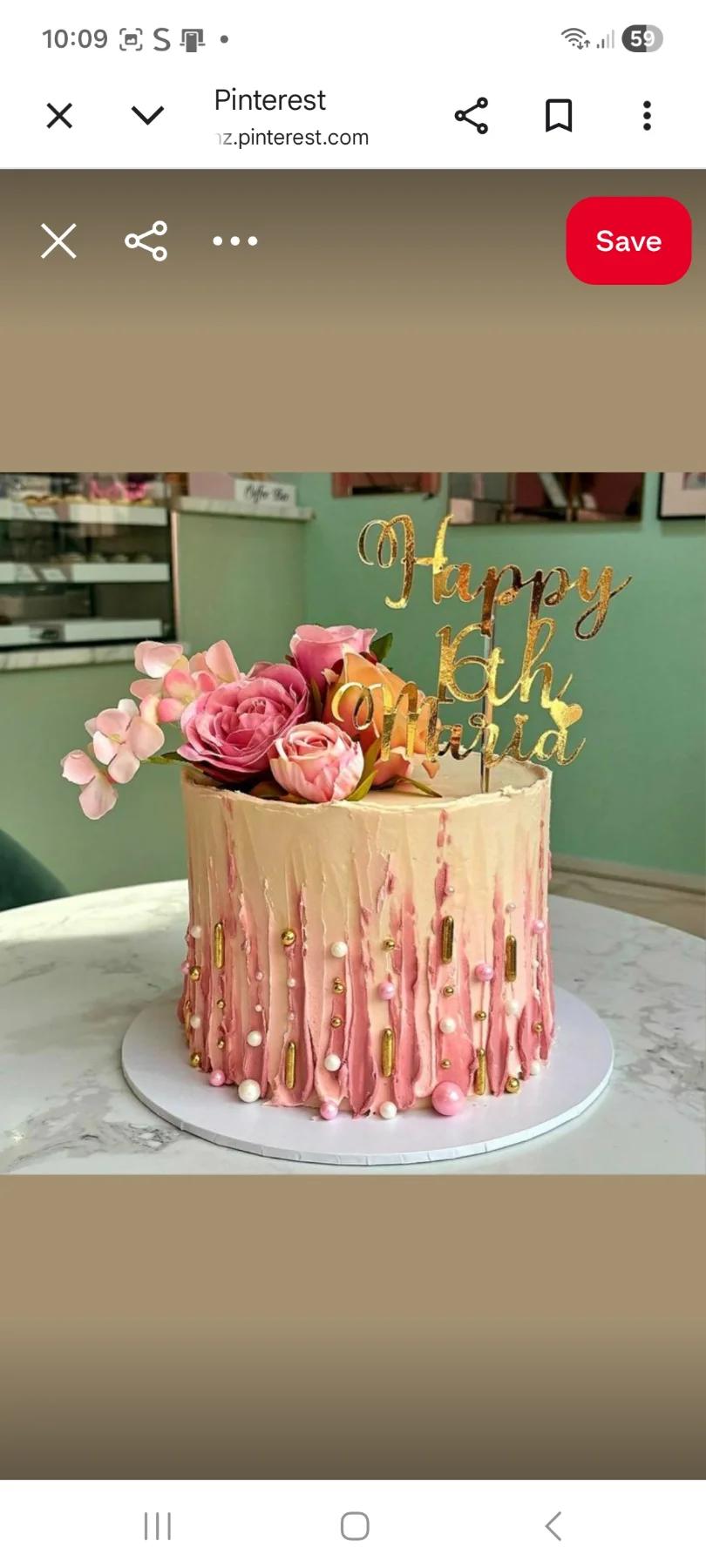 Elegant peach and pink textured buttercream cake with fresh roses, gold sprinkles, and a gold Happy 16th Maria topper.