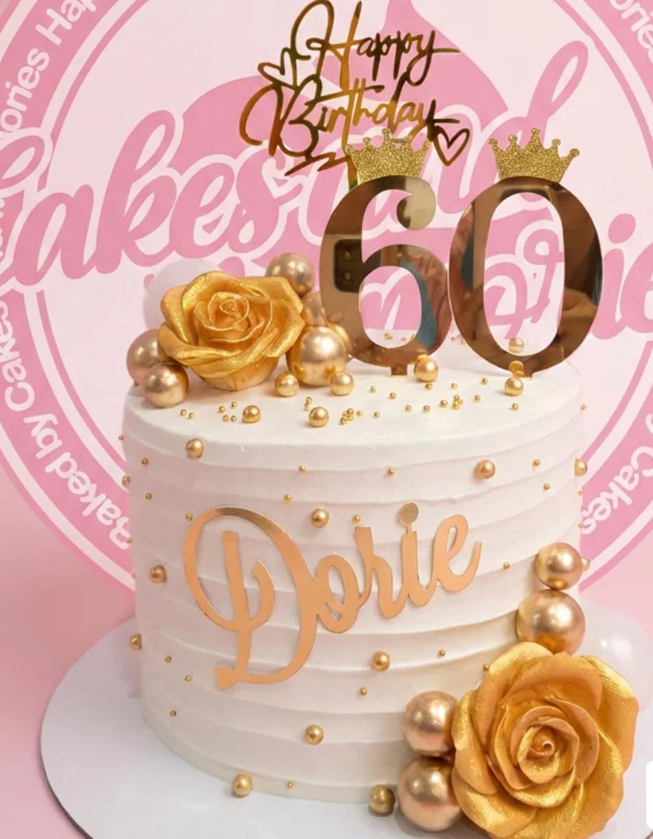 White 1-tier 60th birthday cake with gold roses, gold spheres, and a gold 60 topper with crowns.