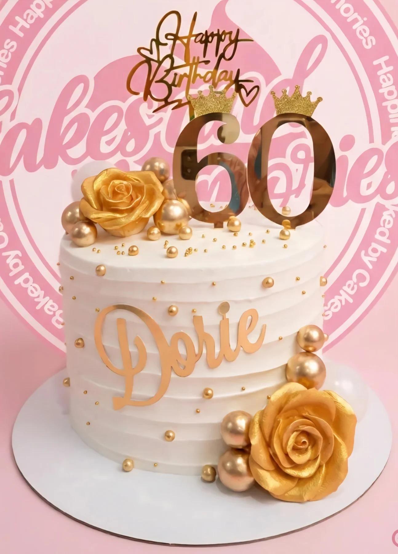 White 1-tier 60th birthday cake with gold roses, gold spheres, and a gold 60 topper with crowns.